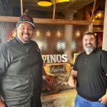 two men in front of restuarant