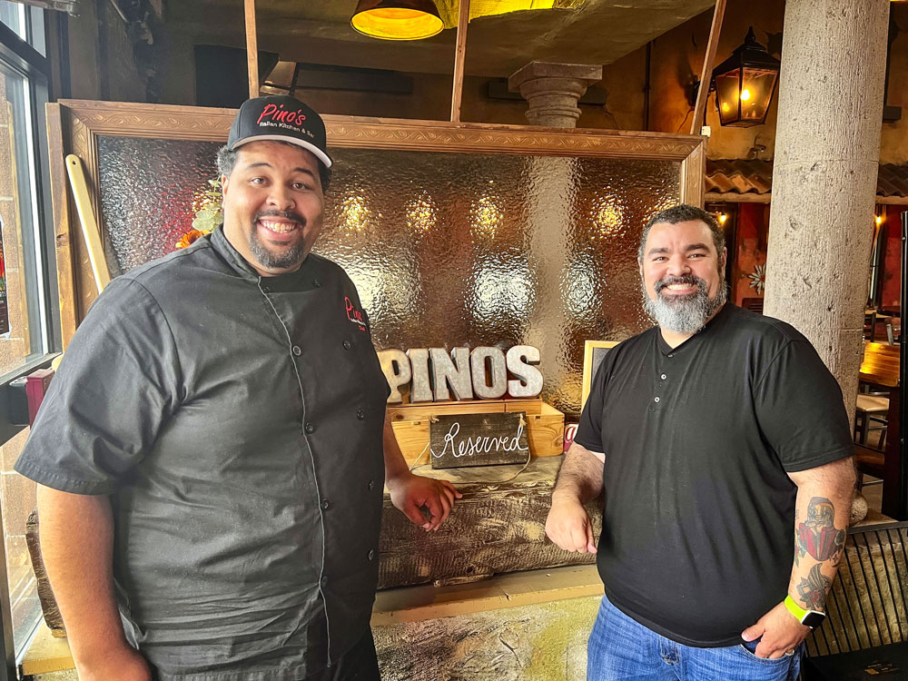 two men in front of restuarant