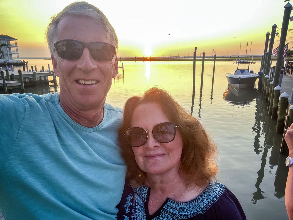 husband and wife in front of water