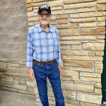 man standing against brick wall