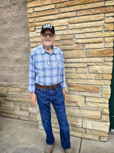 man standing against brick wall