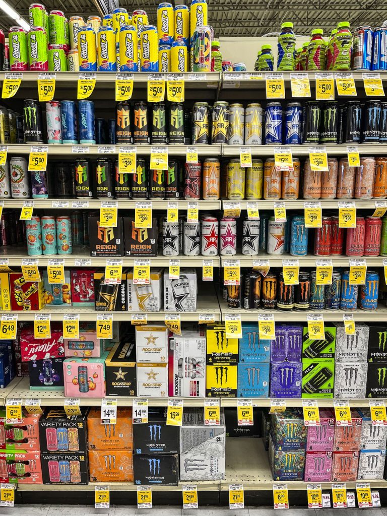 various kinds of energy drink cans on shelves