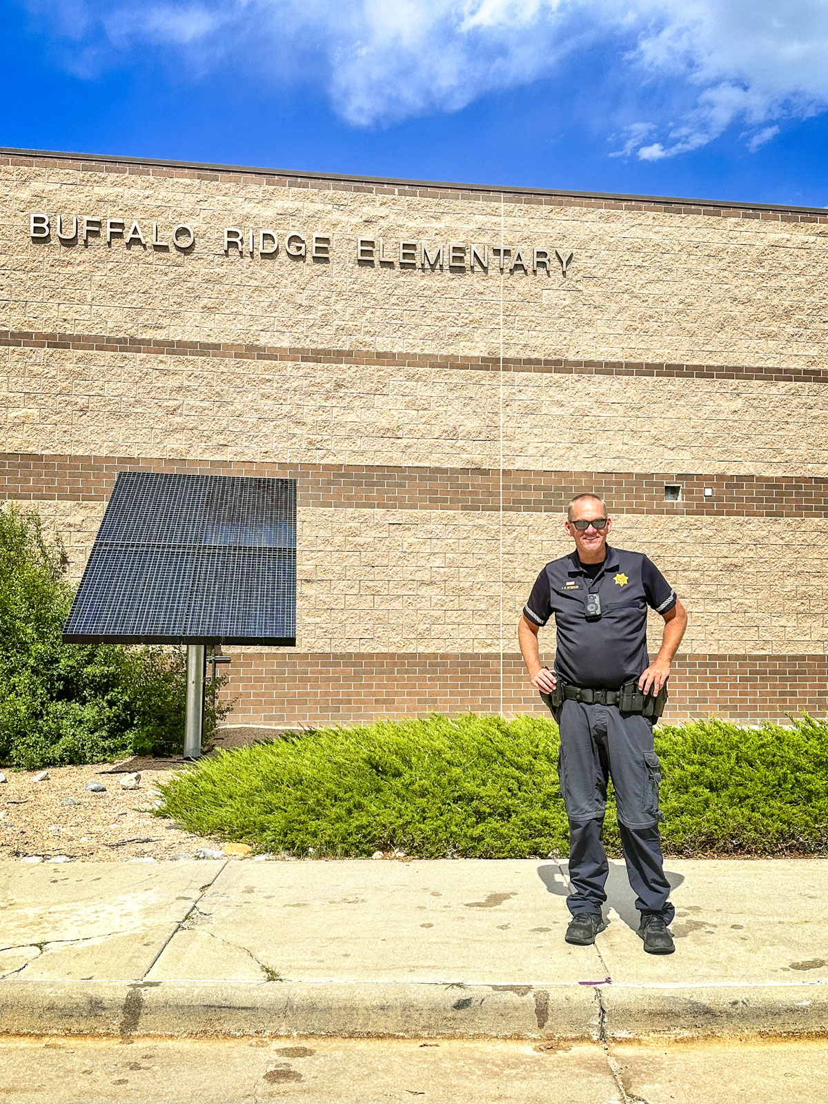 officer standing in front of school