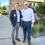 2 men standing in front of hospital