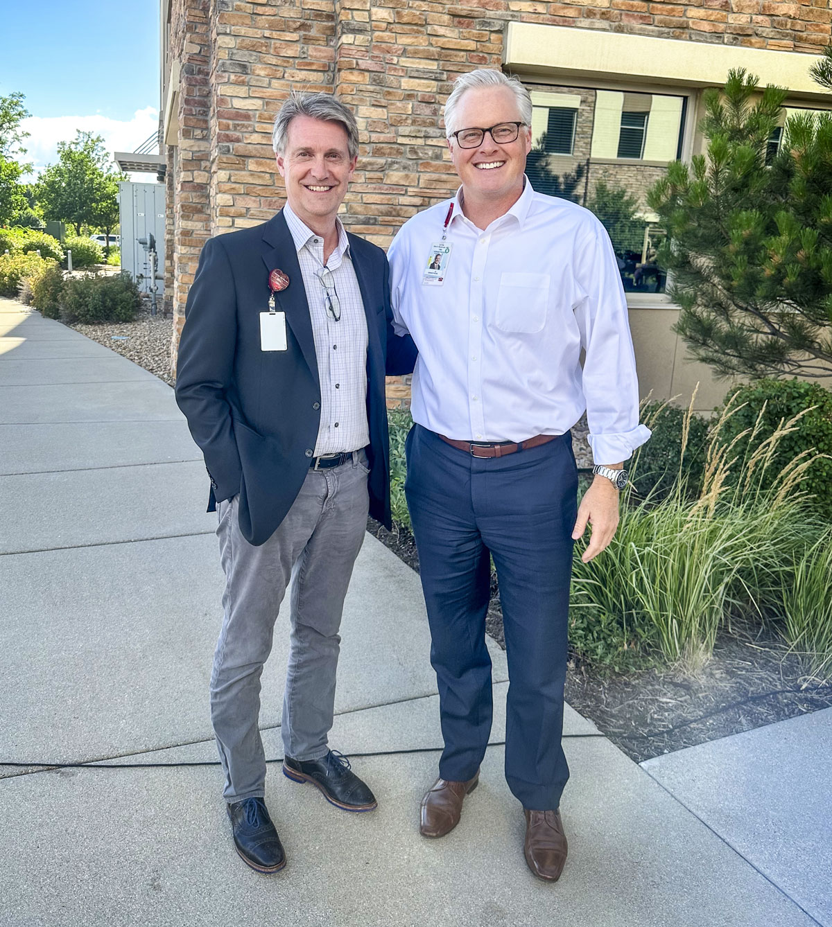2 men standing in front of hospital
