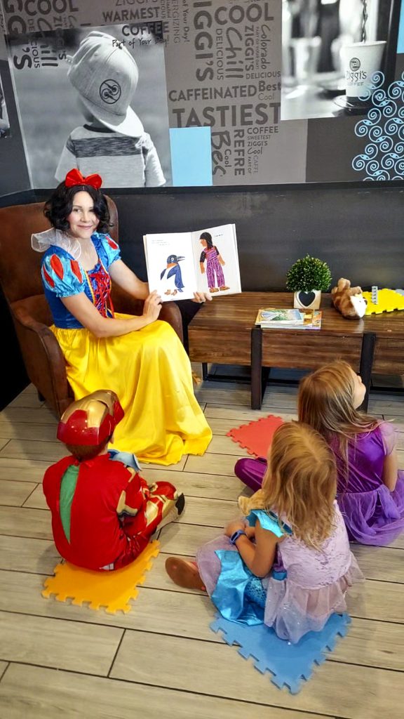 snow white reading to kids at coffee shop