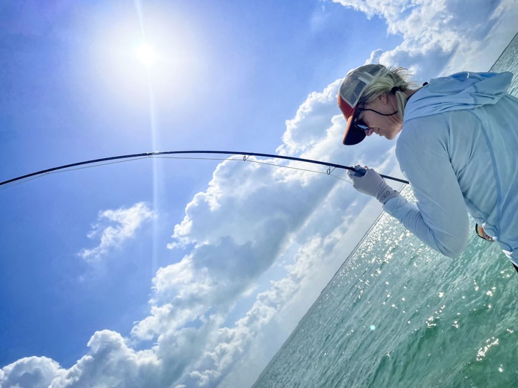 lady fishing in turquoise water