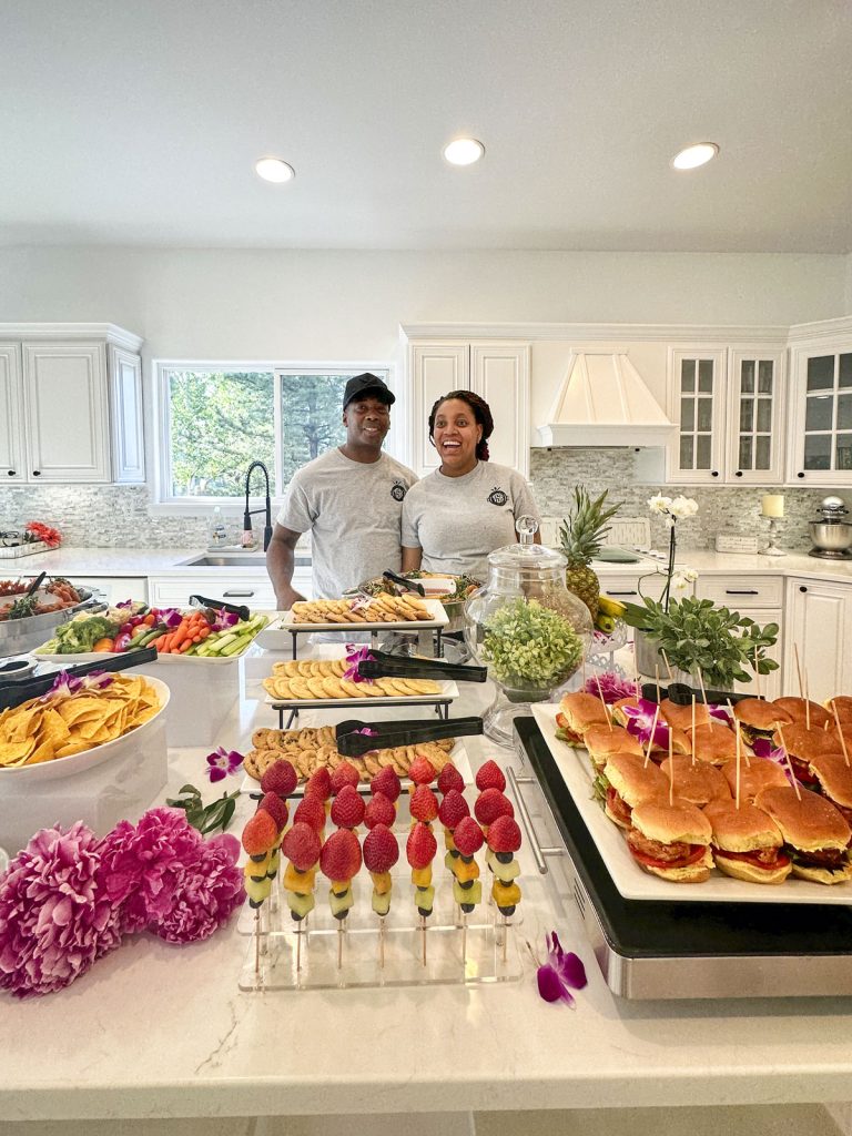 couple in kitchen with various foods