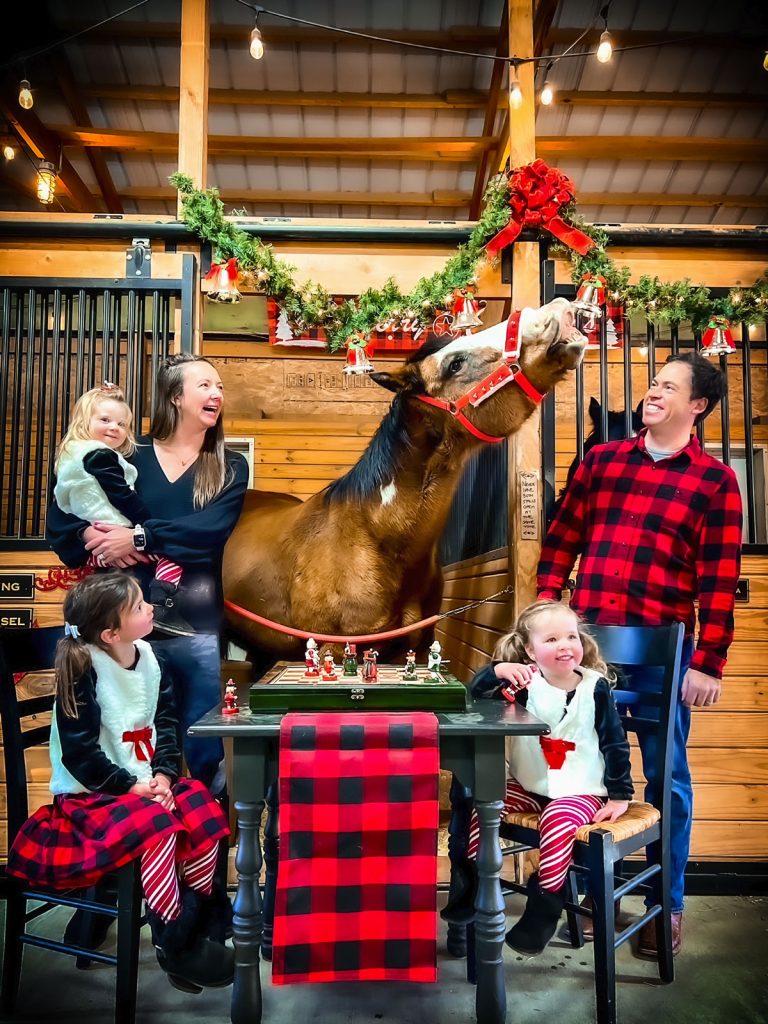 family poses with horse
