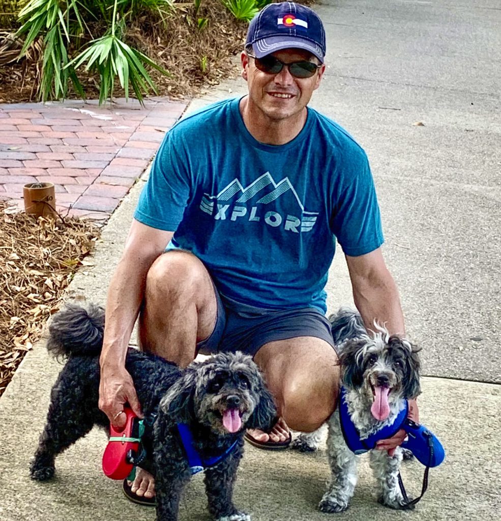 man outside with his dogs