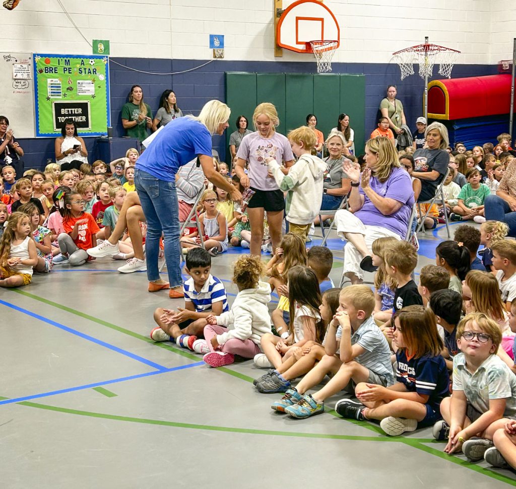 group of kids and teachers in school gym