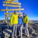 family standing on top of mountain