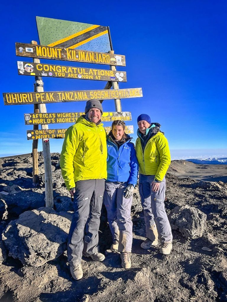 family standing on top of mountain