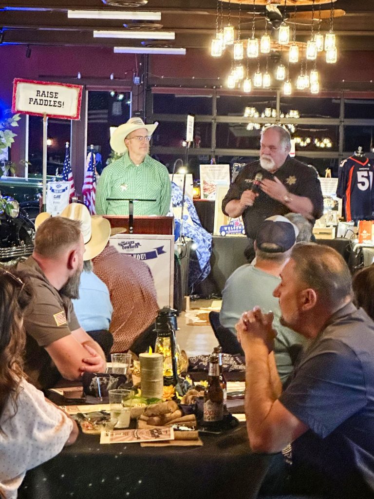 men speaking in front of crowd