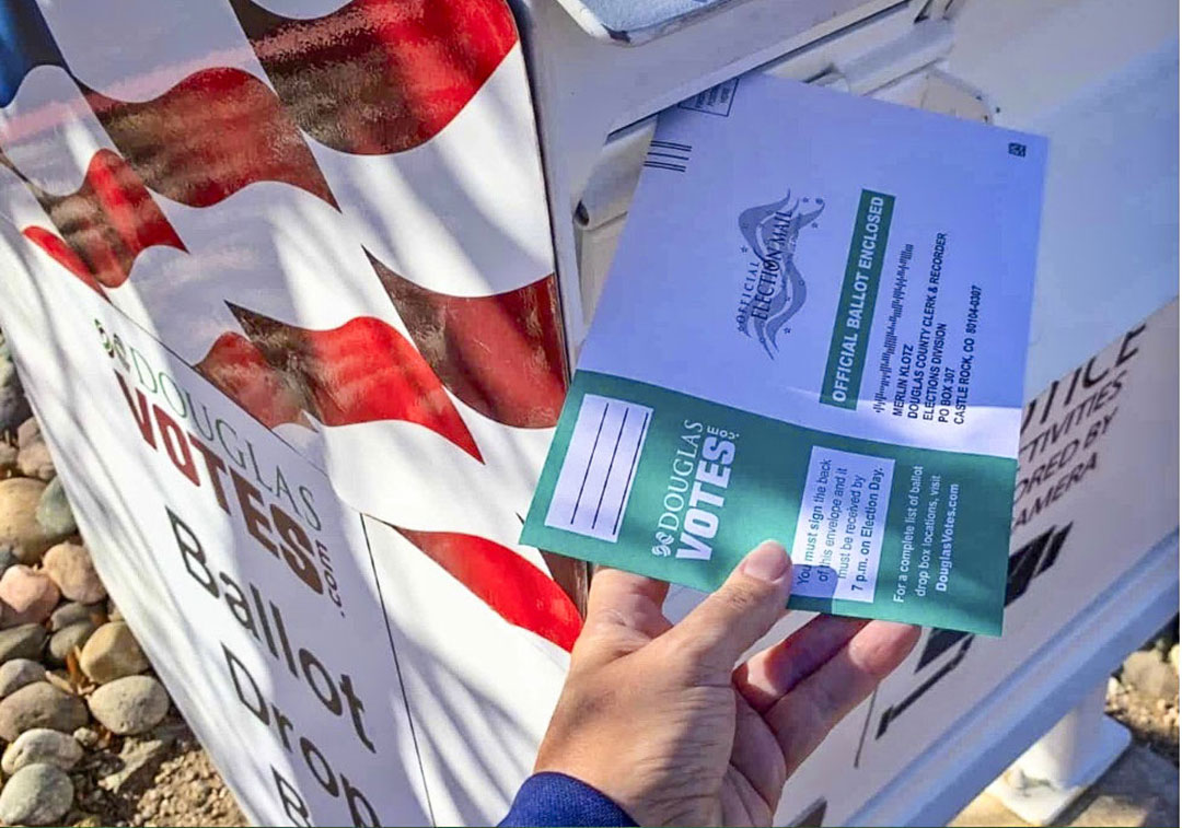 mail vote being dropped off in box