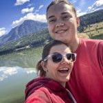 couple in front of lake and mountains