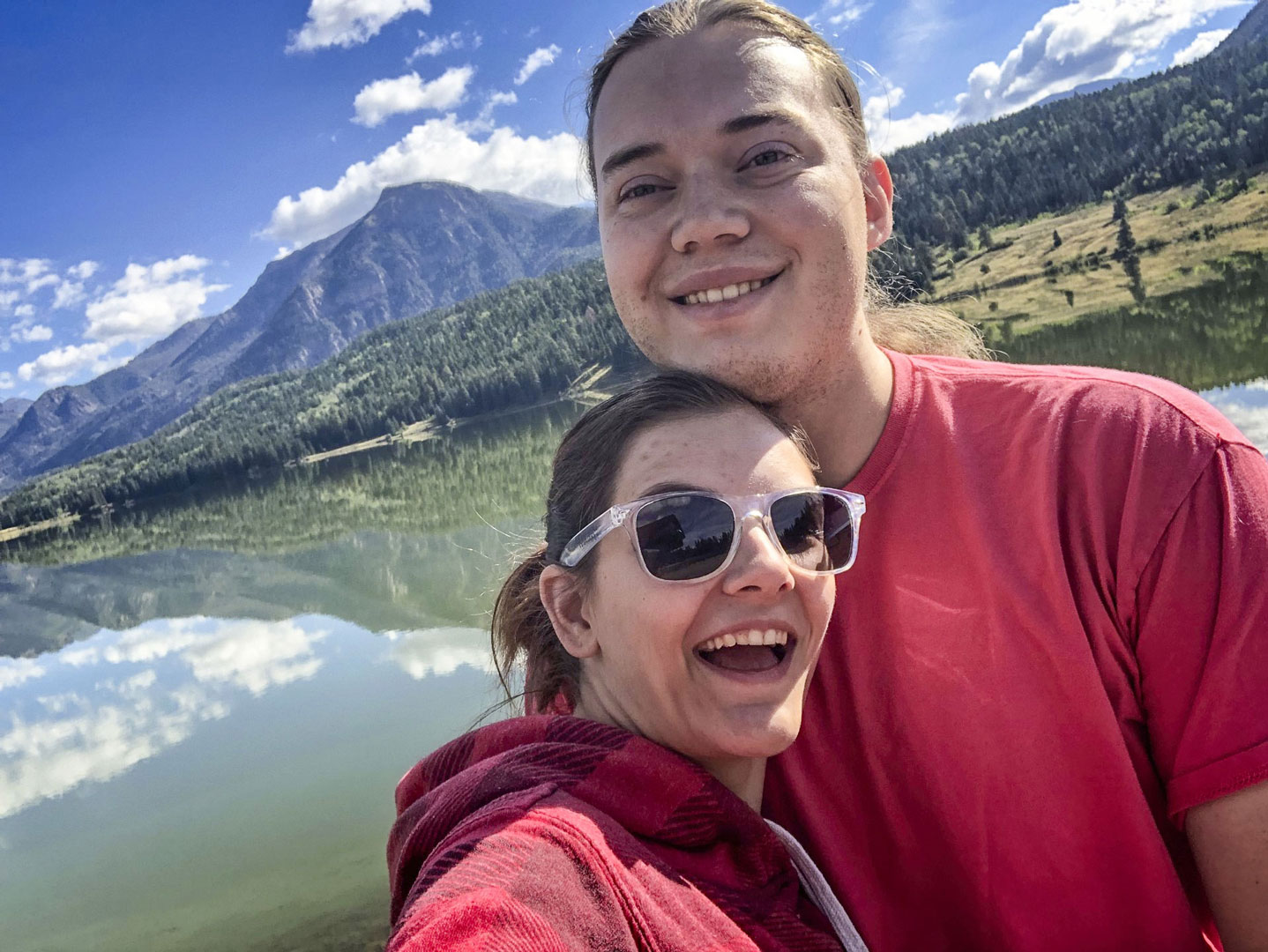 couple in front of lake and mountains