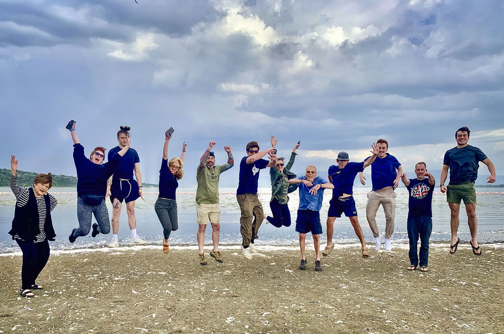 large family jumping on beach