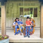 family on front porch with cowboy hats