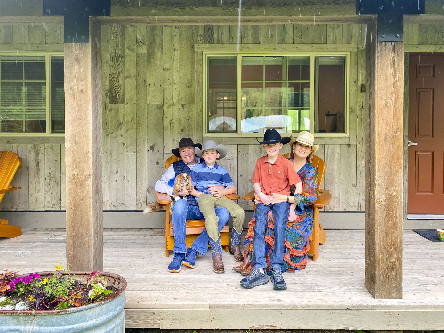 family on front porch with cowboy hats