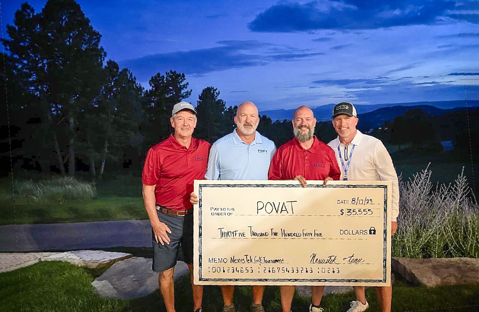 four men holding check outside