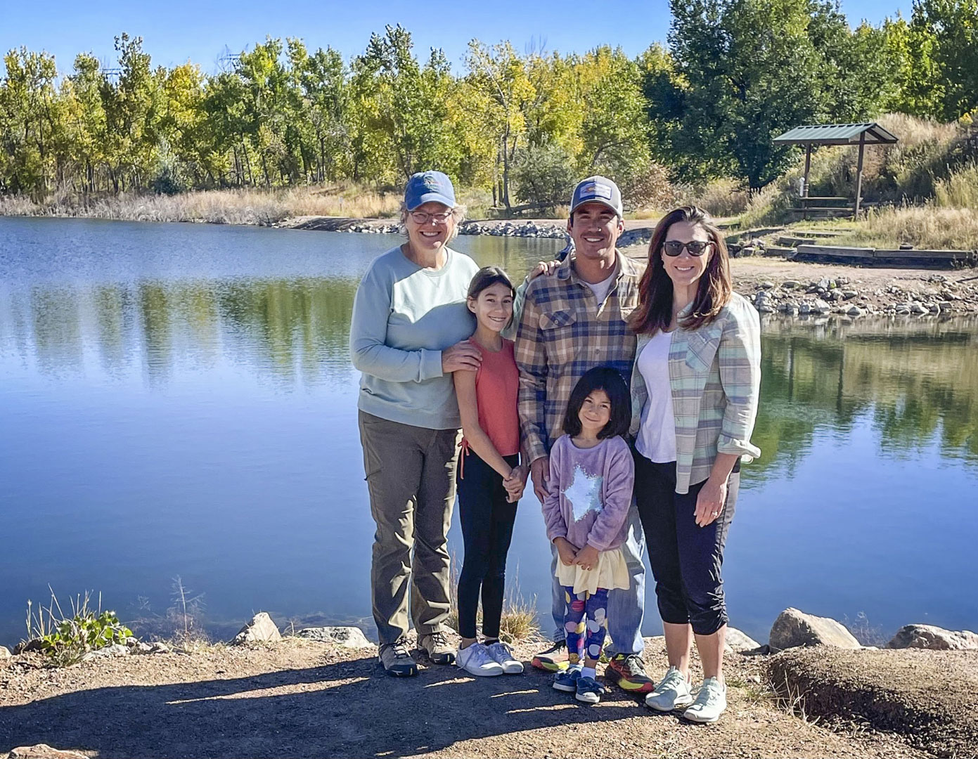 family in front of lake