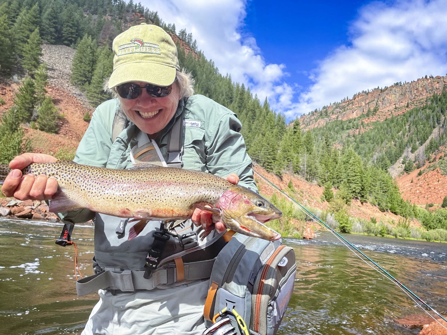 person holding large fish in lake