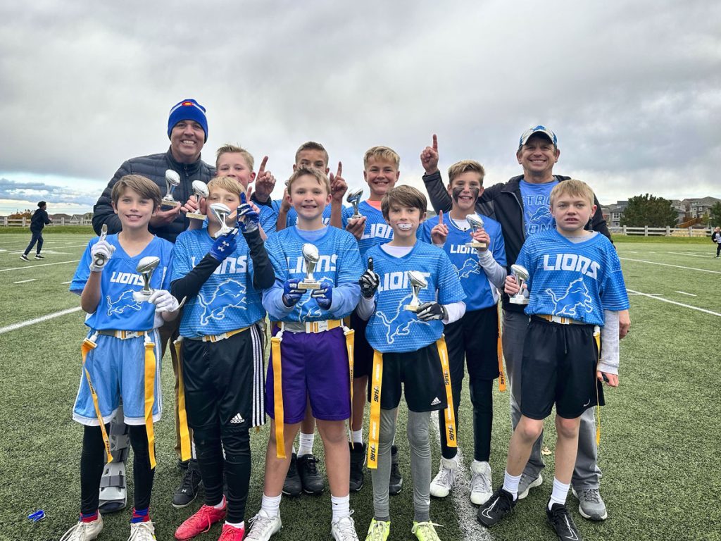 group in blue outside on turf