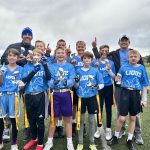 group in blue outside on turf