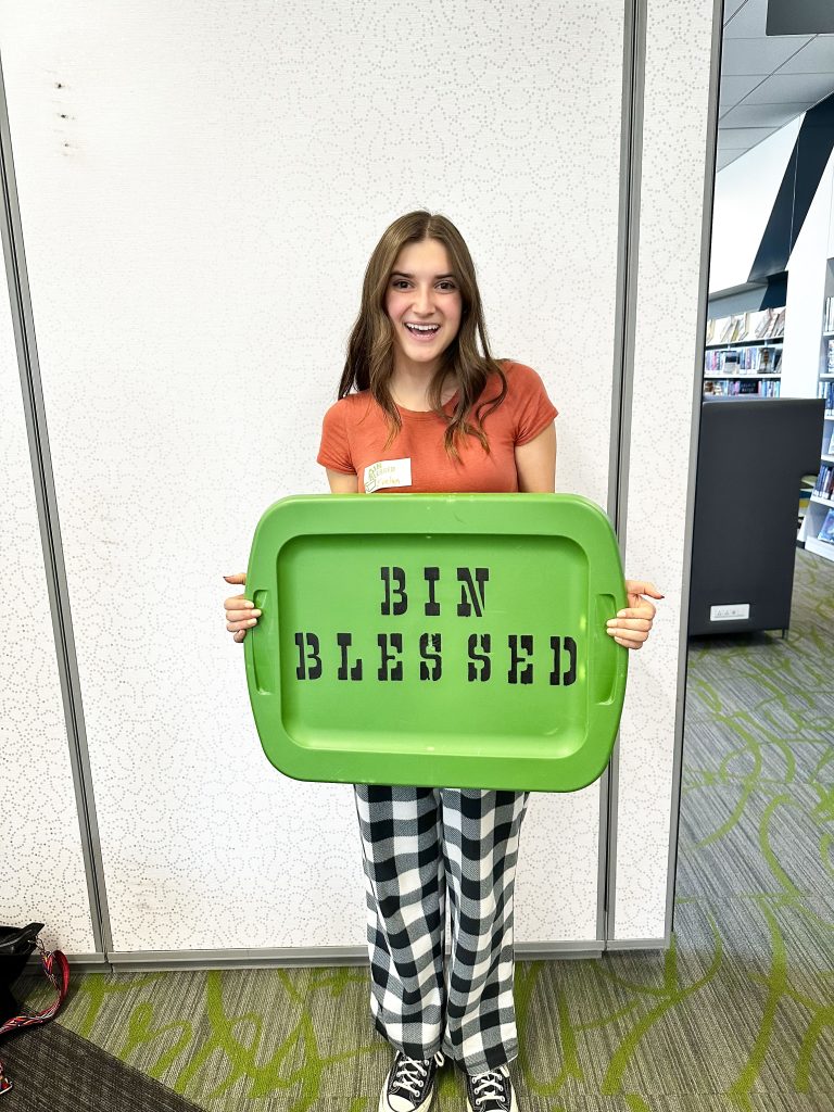 teen holding green bin top