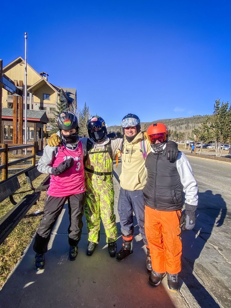 four young adults in cold weather gear