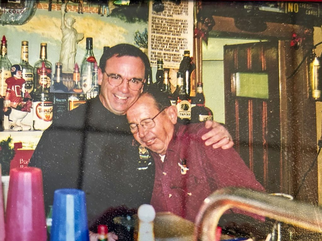 men standing behind bar