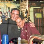 men standing behind bar