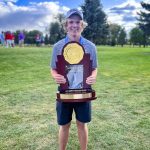 teen holds trophy