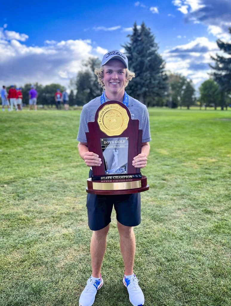 teen holds trophy