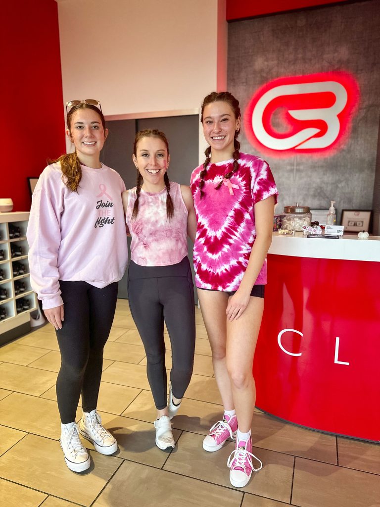 three ladies standing in workout studio