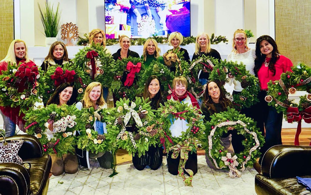 group of ladies holding wreaths