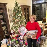 woman holds gifts that were donated