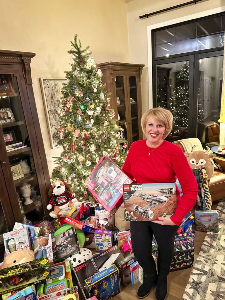 woman holds gifts that were donated