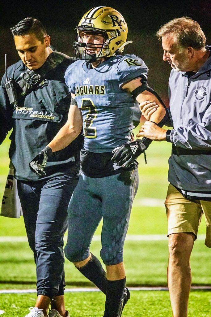 trainer and athlete walk off field