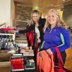 two teachers looking through donations