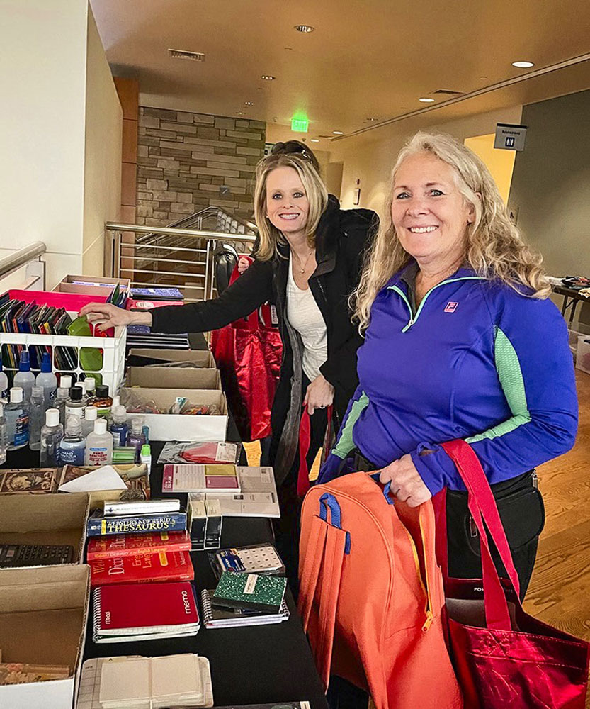 two teachers looking through donations