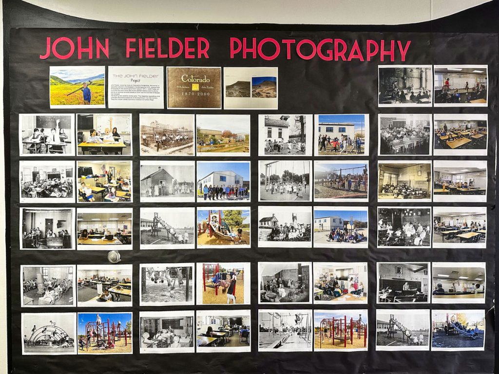 wall with photos attached and sign that says john fielder photography