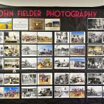 wall with photos attached and sign that says john fielder photography