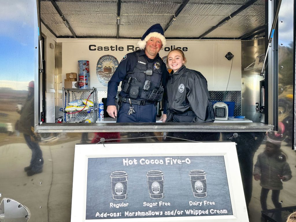 man and woman stand behind food truck counter