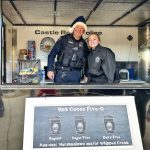 man and woman stand behind food truck counter