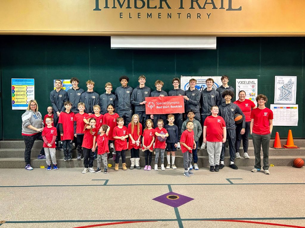 students pose for photo in gym