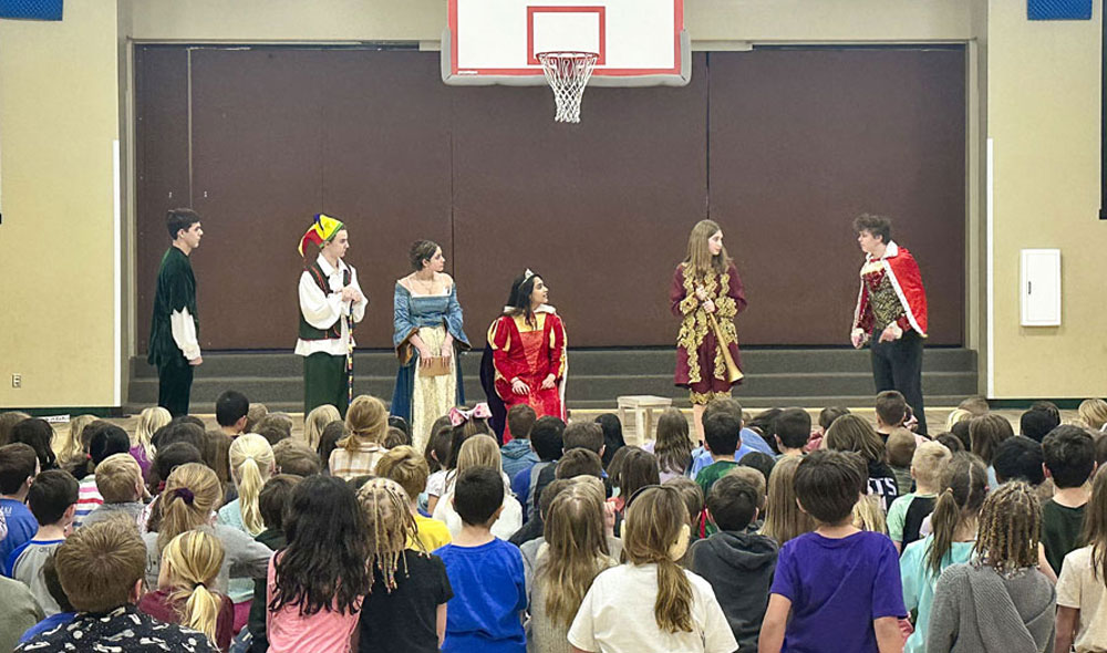 students on stage for play