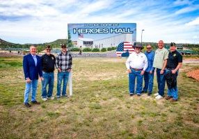 Douglas County Commissioner George Teal gathered with representatives from local veteran organizations on May 21 to celebrate the unveiling of the new sign that designates the future home of the Heroes Hall. 