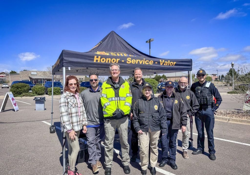 Members of the Castle Pines North Metro District Board and staff joined the Douglas County Sheriff’s Office and its Community Service Volunteer team for the prescription Drug Take Back Day in Castle Pines. Inset: Sheriff Darren Weekly.